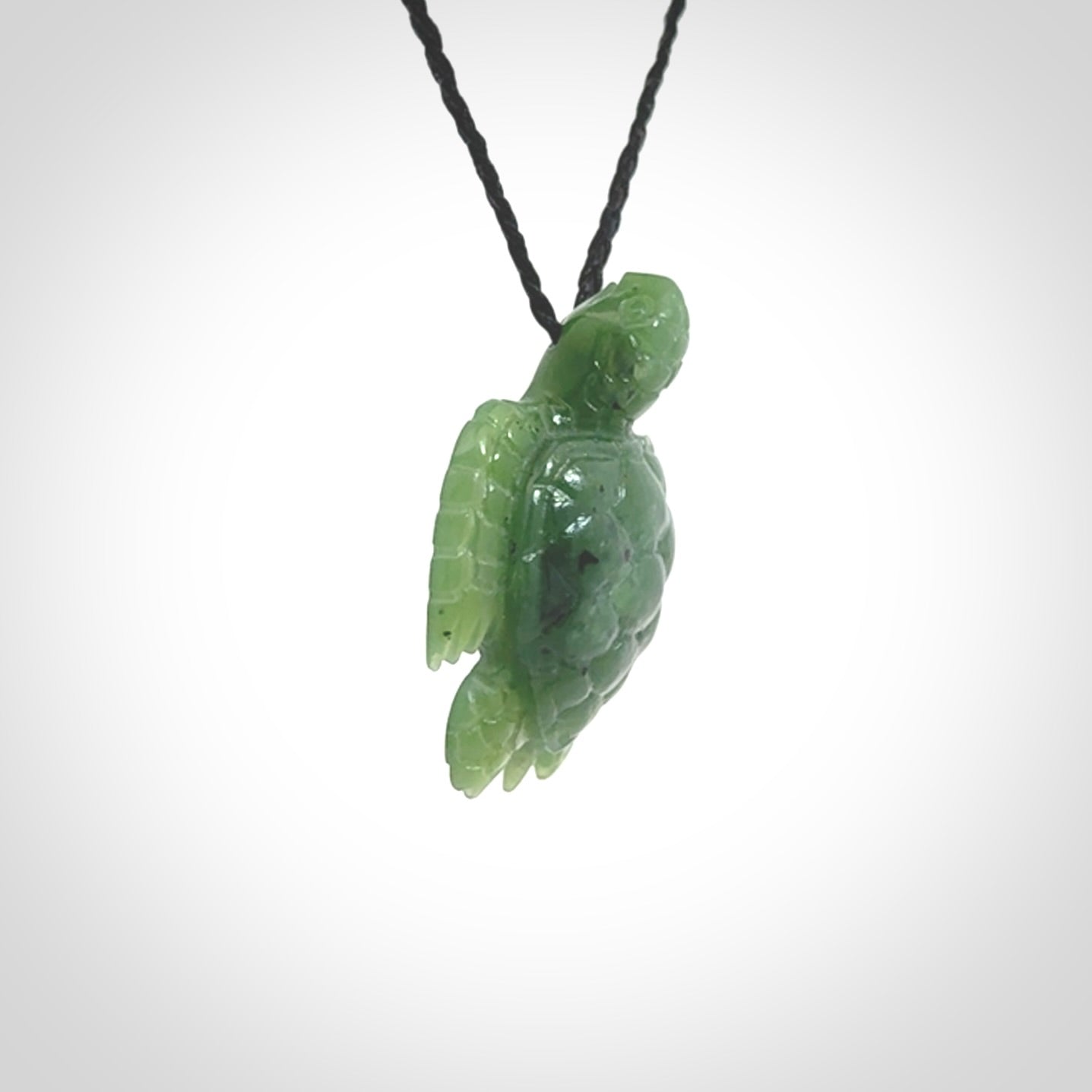 British Columbian jade turtle pendant. Hand carved jade turtle pendant, made by NZ Pacific for sale online. Unique handmade jewellery. Provided with an adjustable cord and packaged in a woven kete pouch.