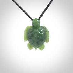 British Columbian jade turtle pendant. Hand carved jade turtle pendant, made by NZ Pacific for sale online. Unique handmade jewellery. Provided with an adjustable cord and packaged in a woven kete pouch.