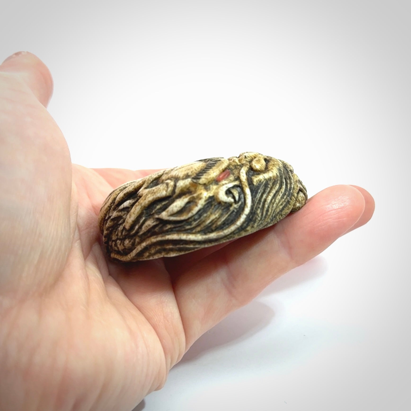 Hand carved red eyed dragon in the clouds made from Deer antler Crown with Mother of Pearl and Gold Leaf. Hand made by master bone carver Fumio Noguchi. Spectacular collectable work of art to display. One only, delivered to you at no extra cost with express courier.