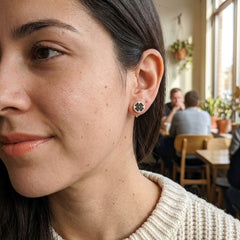 Woman wearing bone stud earrings