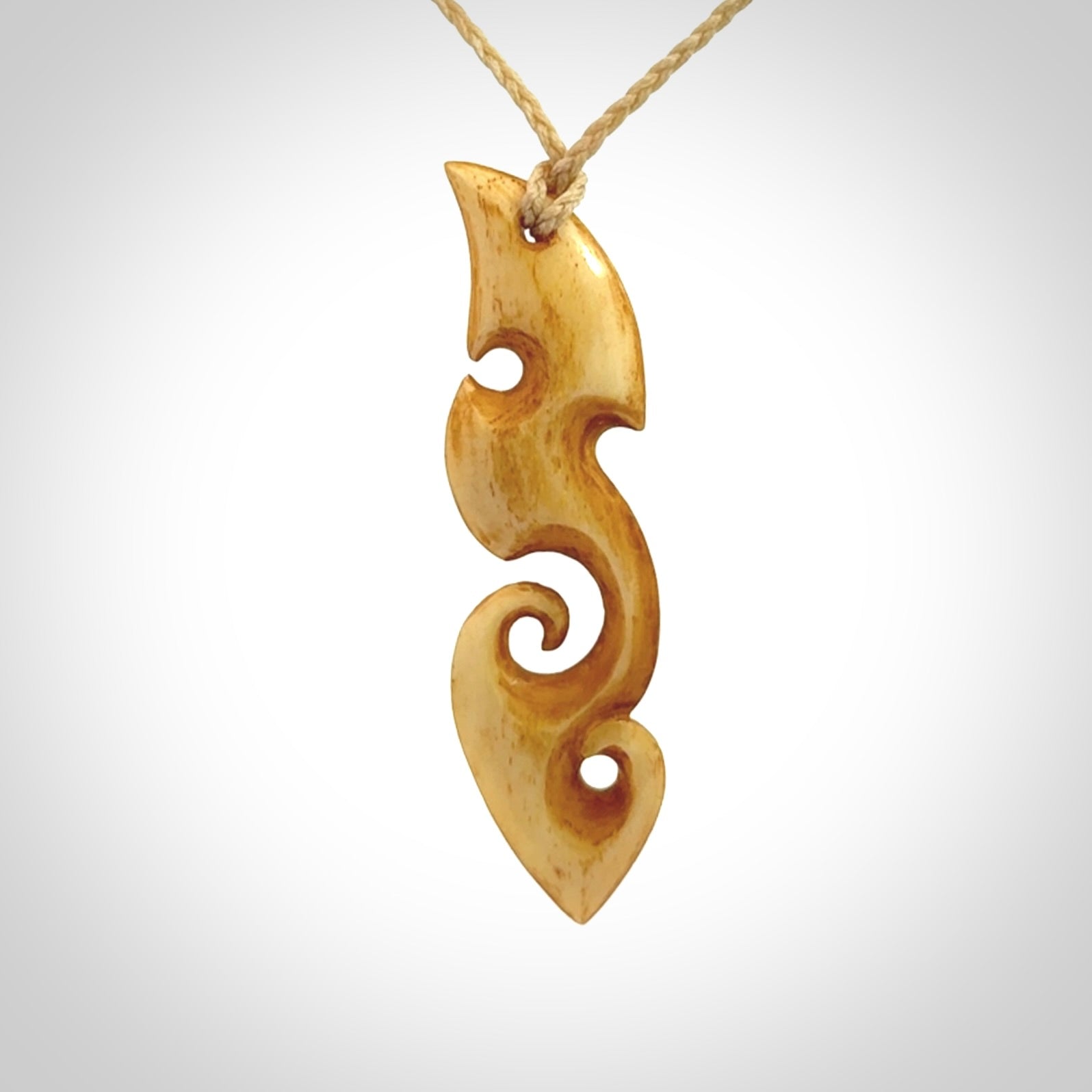 This is a wonderful, contemporary large koru from stained bone. Hand carved and provided with an adjustable oat cord.