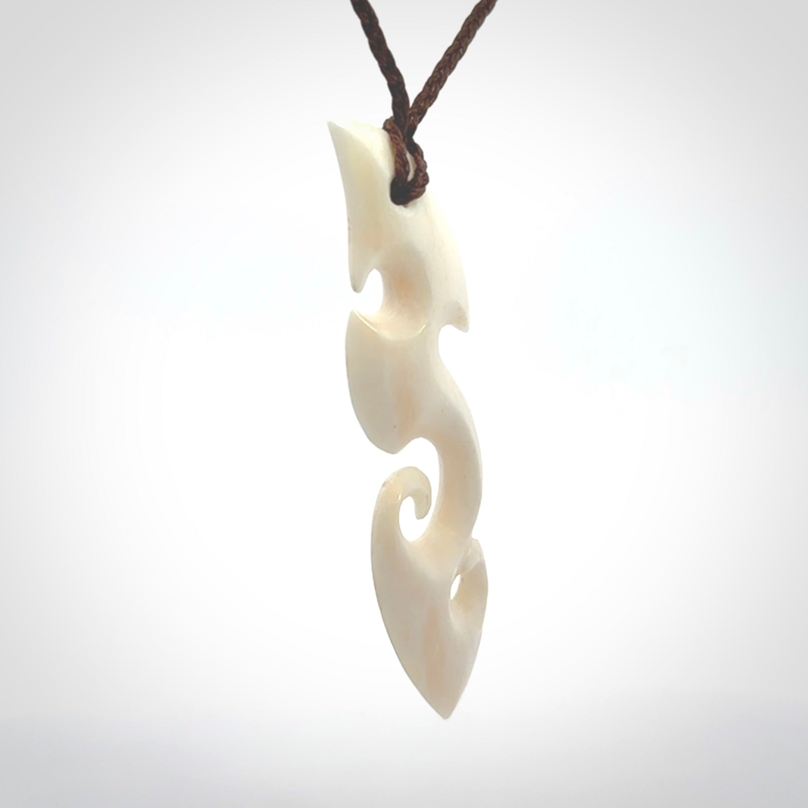 This is a wonderful, contemporary large koru from bone. Hand carved and provided with an adjustable brown cord.
