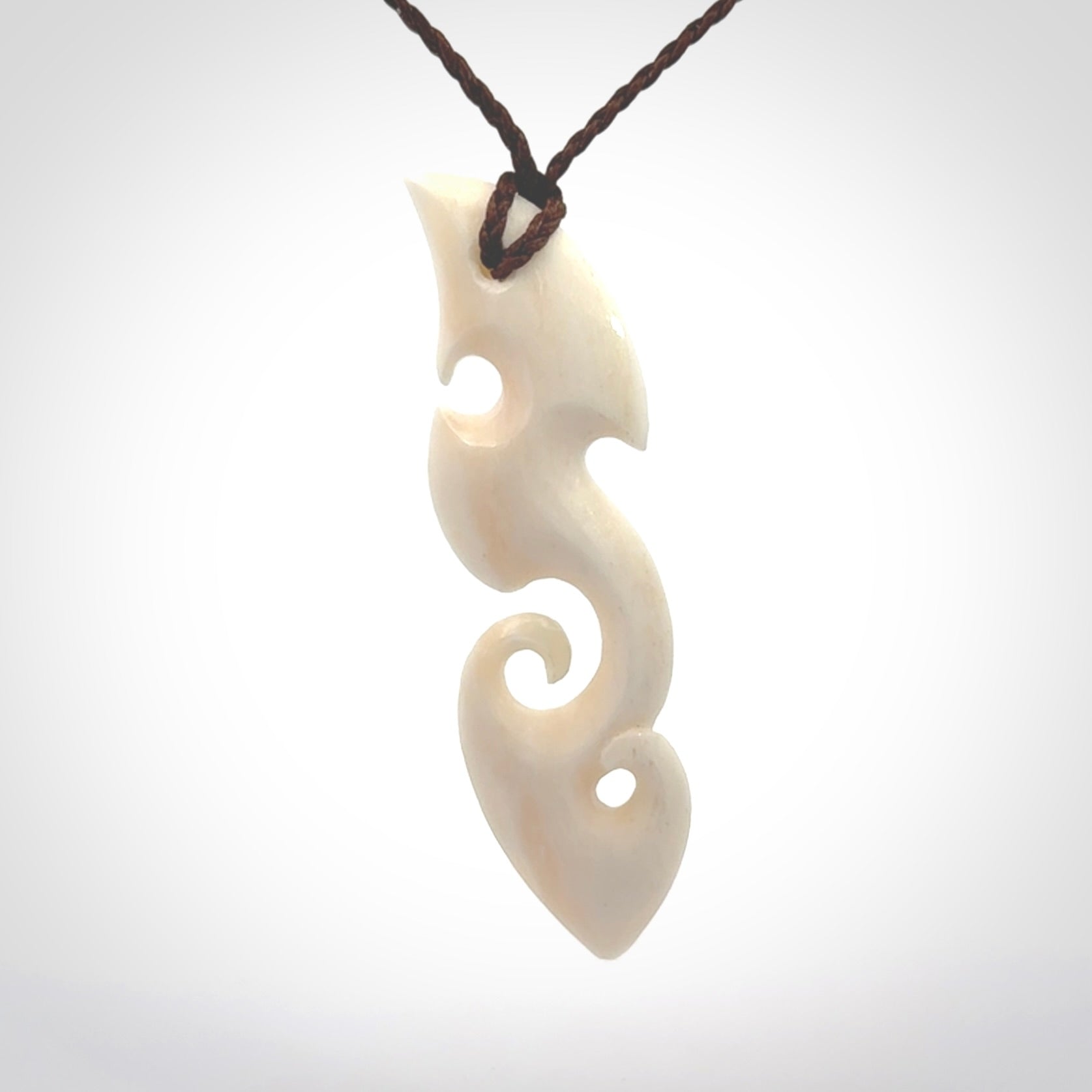 This is a wonderful, contemporary large koru from bone. Hand carved and provided with an adjustable brown cord.