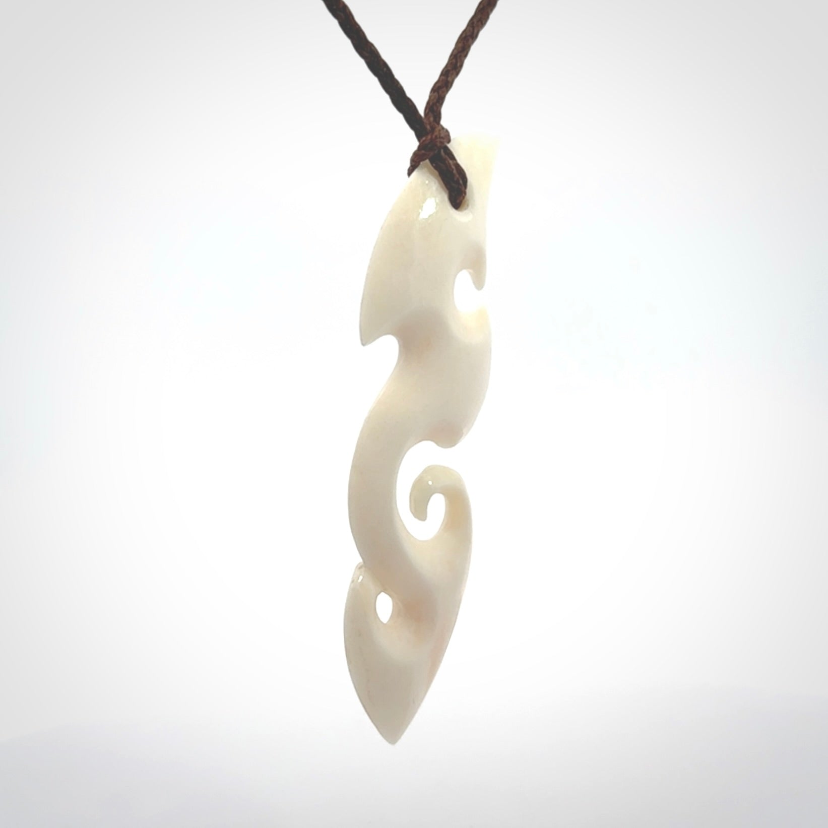 This is a wonderful, contemporary large koru from bone. Hand carved and provided with an adjustable brown cord.