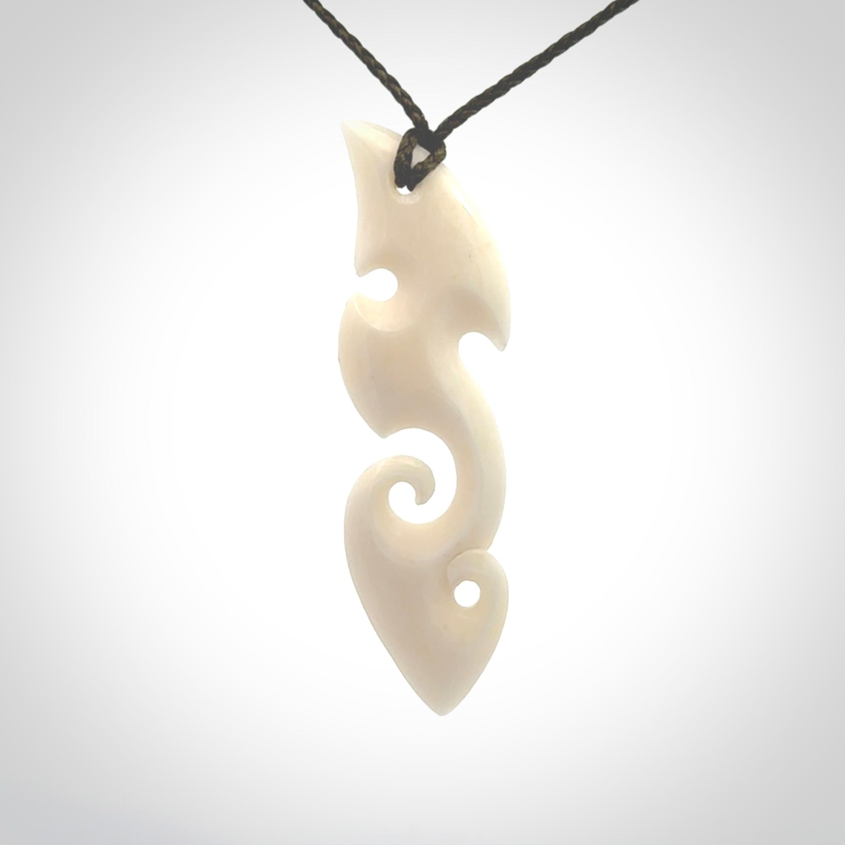 This is a wonderful, contemporary large koru from bone. Hand carved and provided with an adjustable olive cord.