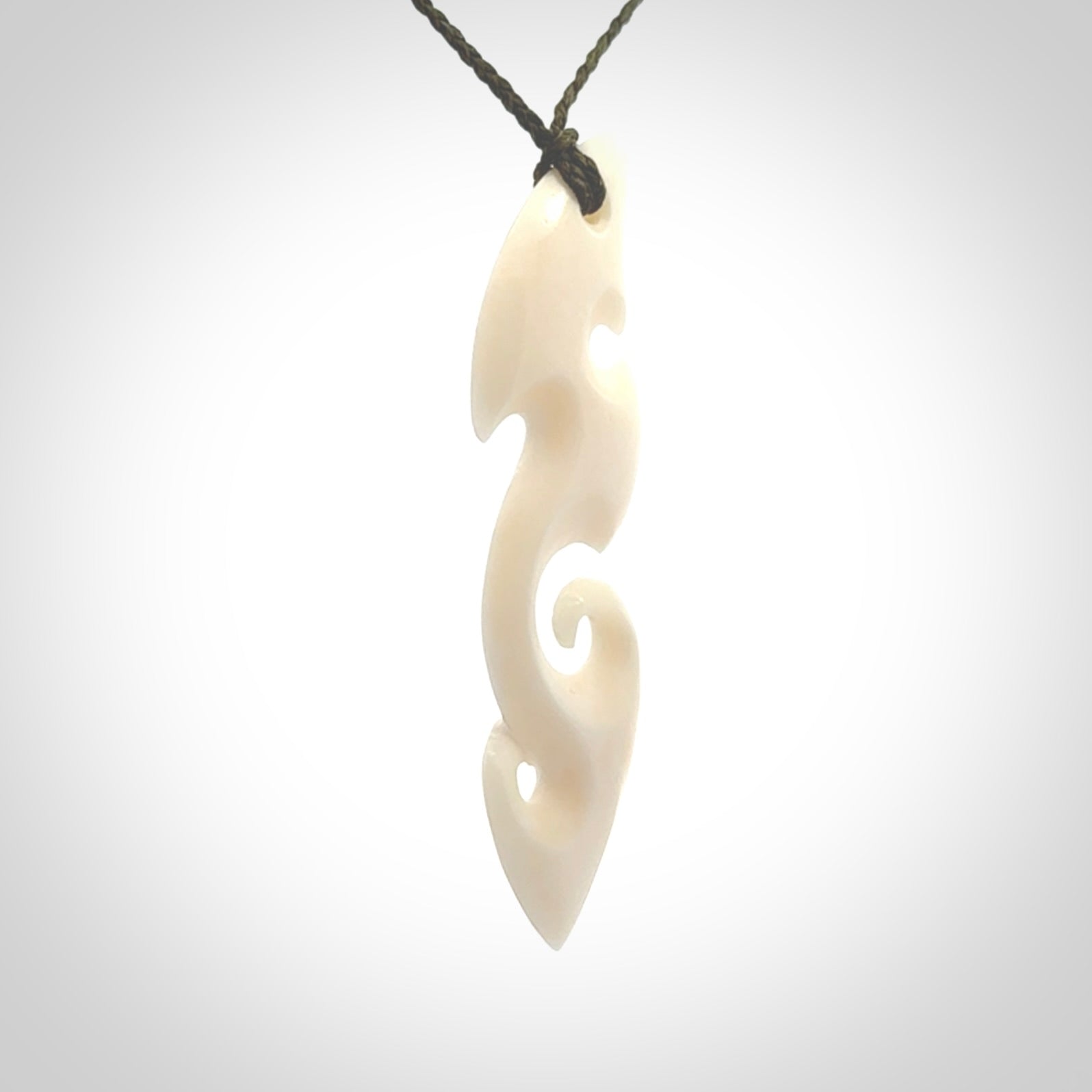 This is a wonderful, contemporary large koru from bone. Hand carved and provided with an adjustable olive cord.