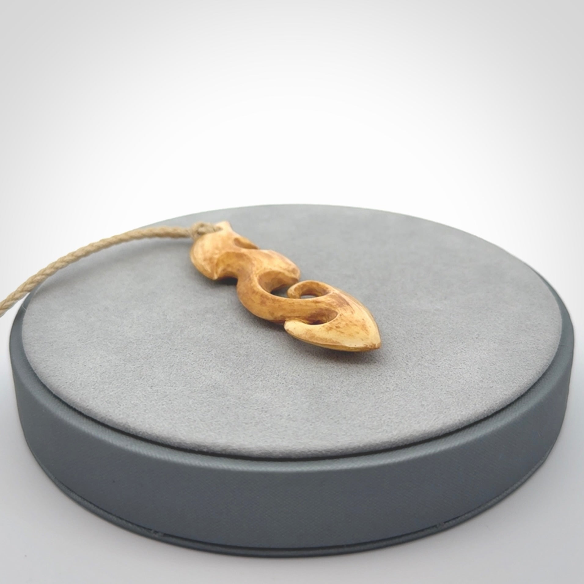 This is a wonderful, contemporary large koru from stained bone. Hand carved and provided with an adjustable oat cord.