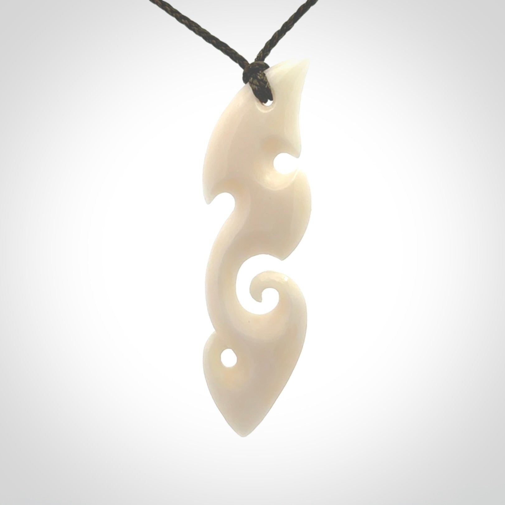 This is a wonderful, contemporary large koru from bone. Hand carved and provided with an adjustable olive cord.