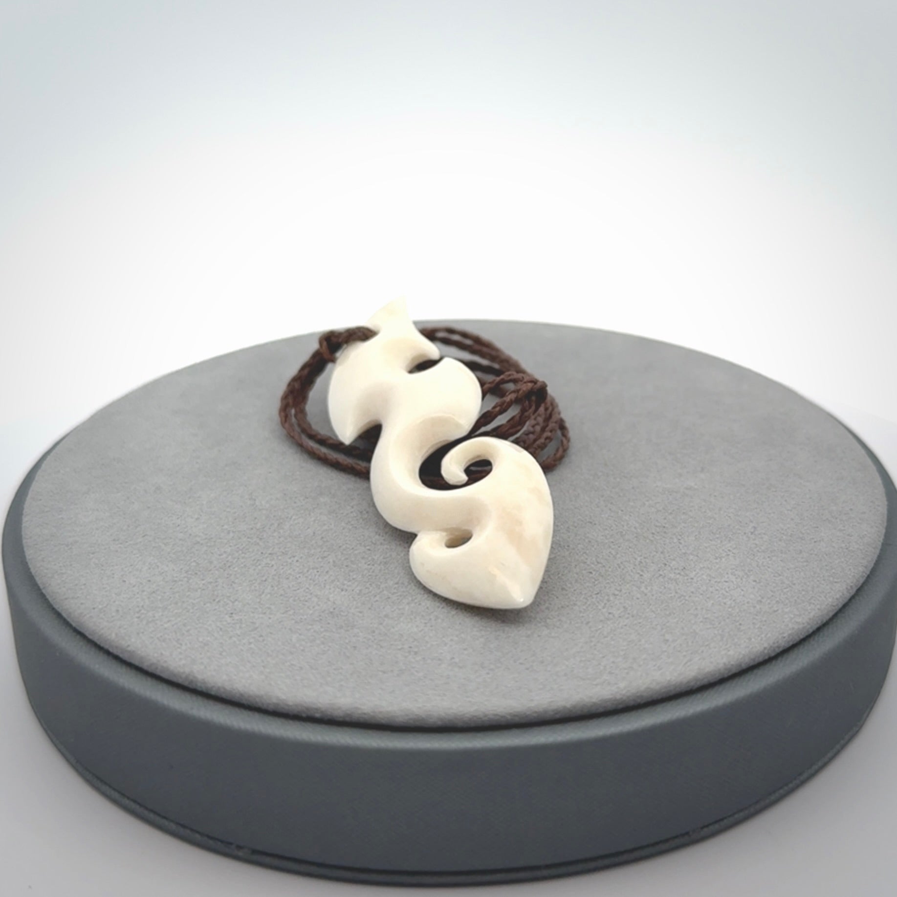 This is a wonderful, contemporary large koru from bone. Hand carved and provided with an adjustable brown cord.
