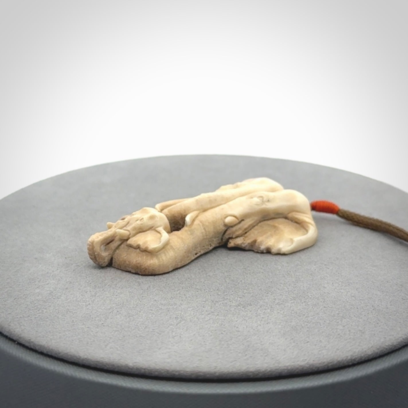 This is a triple elephant pendant, carved in a Deer Antler. The cord is length adjustable. Provided in a woven kete pouch and delivered with express courier.