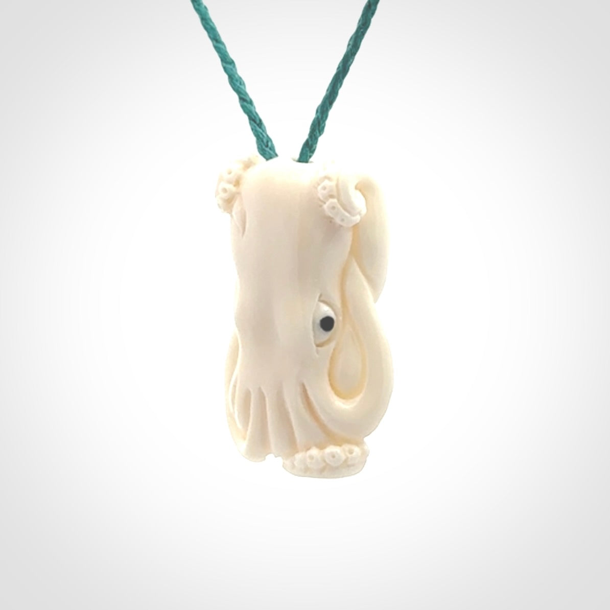 This is a beautiful little hand carved octopus pendant. It is a very cute little pendant that we have carved in natural, untreated bone. We provide these with adjustable cords and shipping is included worldwide.