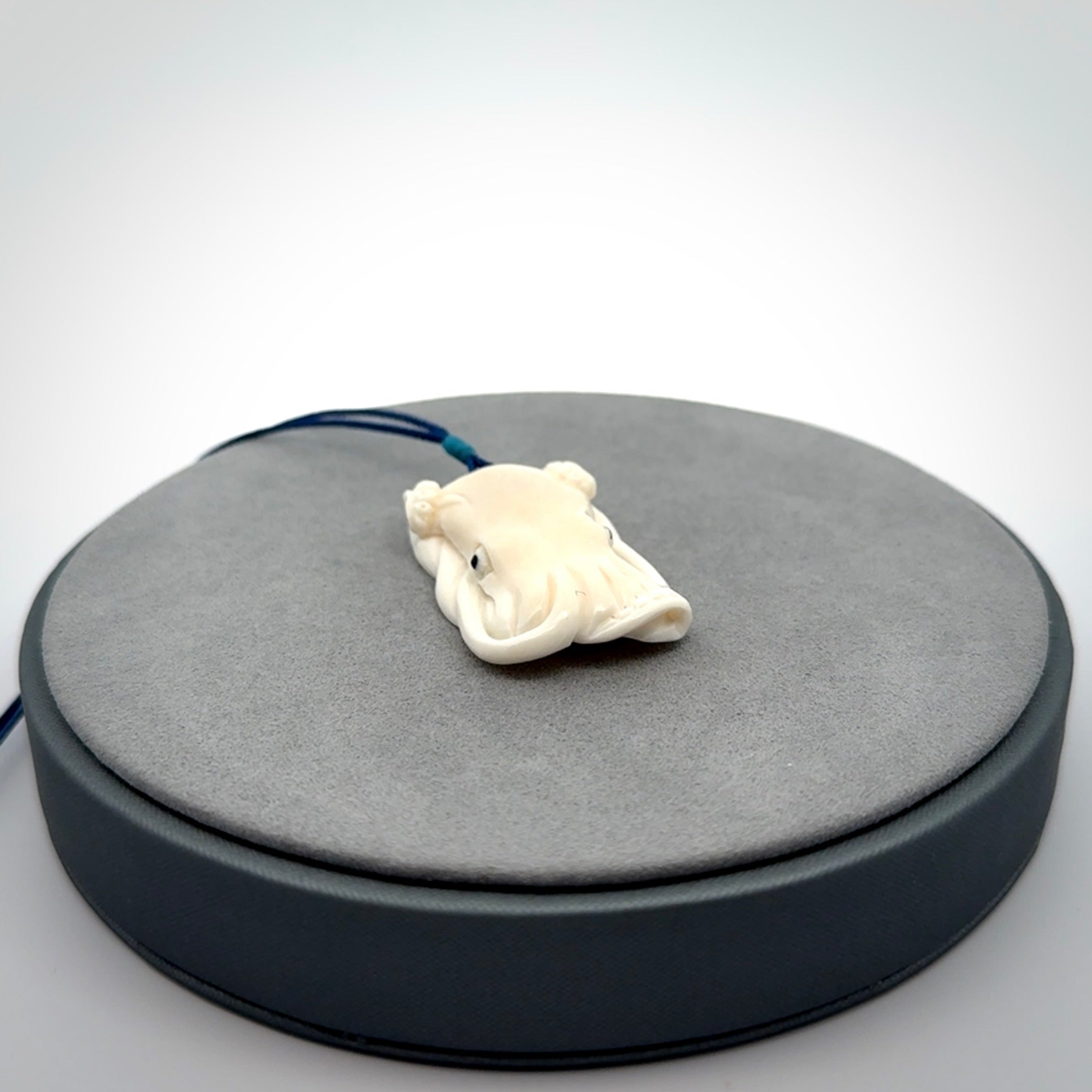 This is a beautiful little hand carved octopus pendant. It is a very cute little pendant that we have carved in natural, untreated bone. We provide these with adjustable cords and shipping is included worldwide.