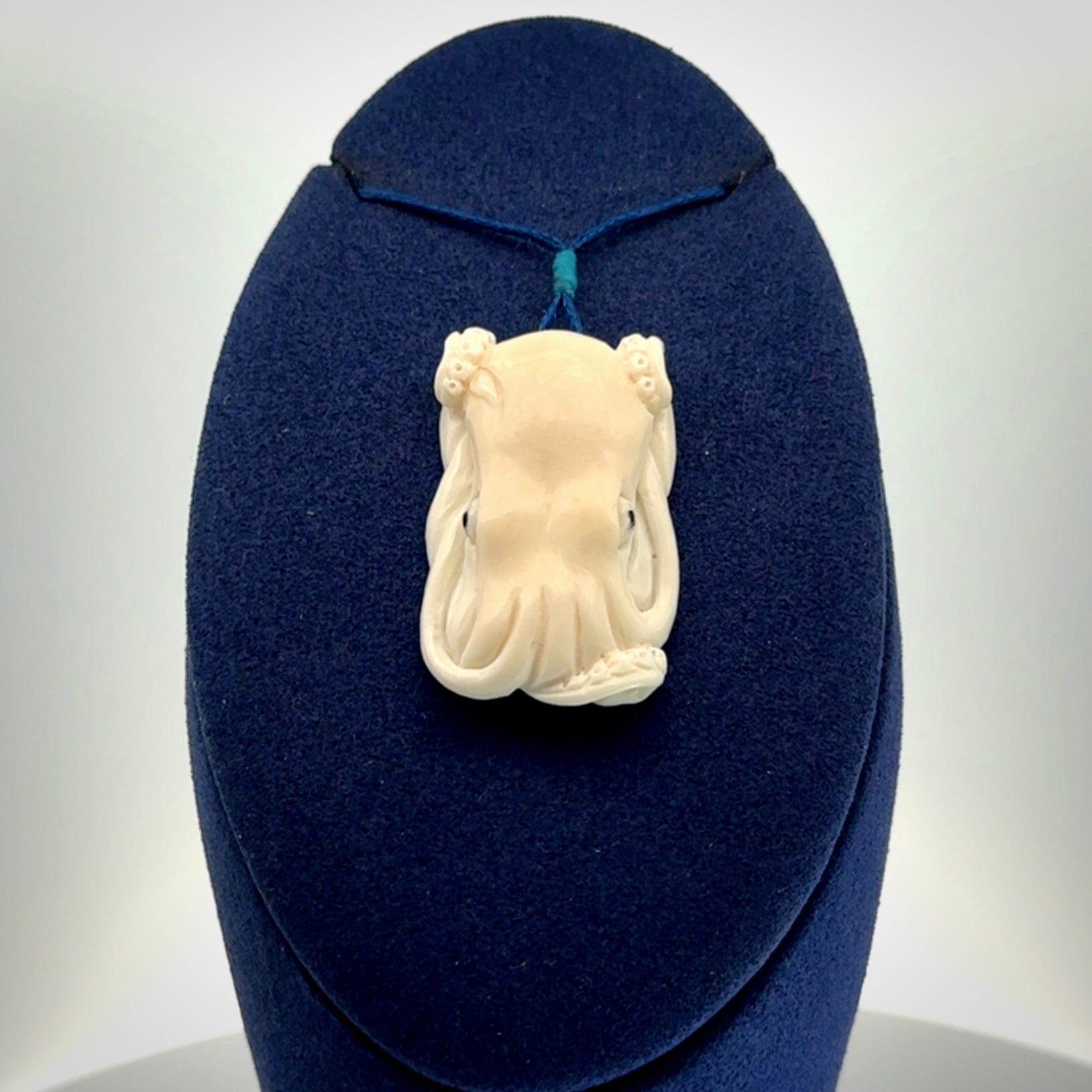 This is a beautiful little hand carved octopus pendant. It is a very cute little pendant that we have carved in natural, untreated bone. We provide these with adjustable cords and shipping is included worldwide.