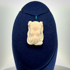 This is a beautiful little hand carved octopus pendant. It is a very cute little pendant that we have carved in natural, untreated bone. We provide these with adjustable cords and shipping is included worldwide.