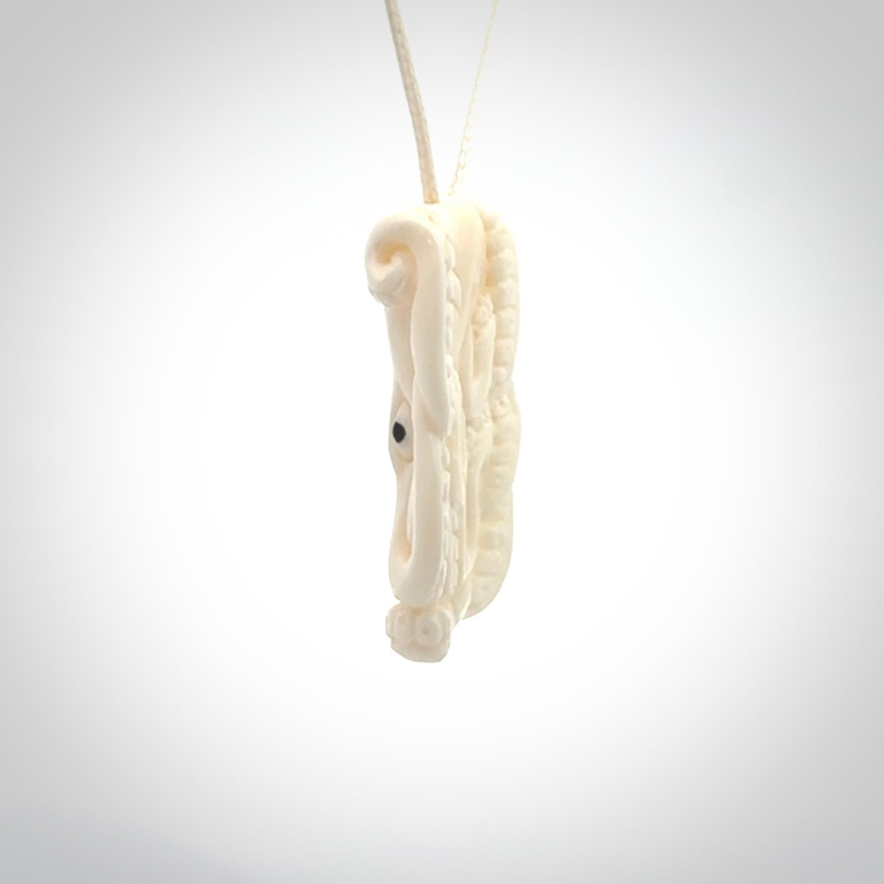 This is a beautiful little hand carved octopus pendant. It is a very cute little pendant that we have carved in natural, untreated bone. We provide these with meringue adjustable cords and shipping is included worldwide.