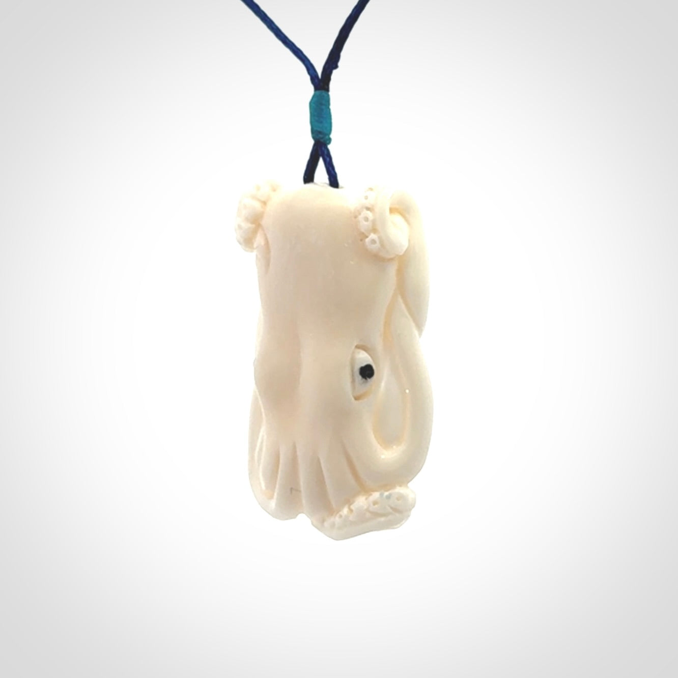This is a beautiful little hand carved octopus pendant. It is a very cute little pendant that we have carved in natural, untreated bone. We provide these with adjustable cords and shipping is included worldwide.
