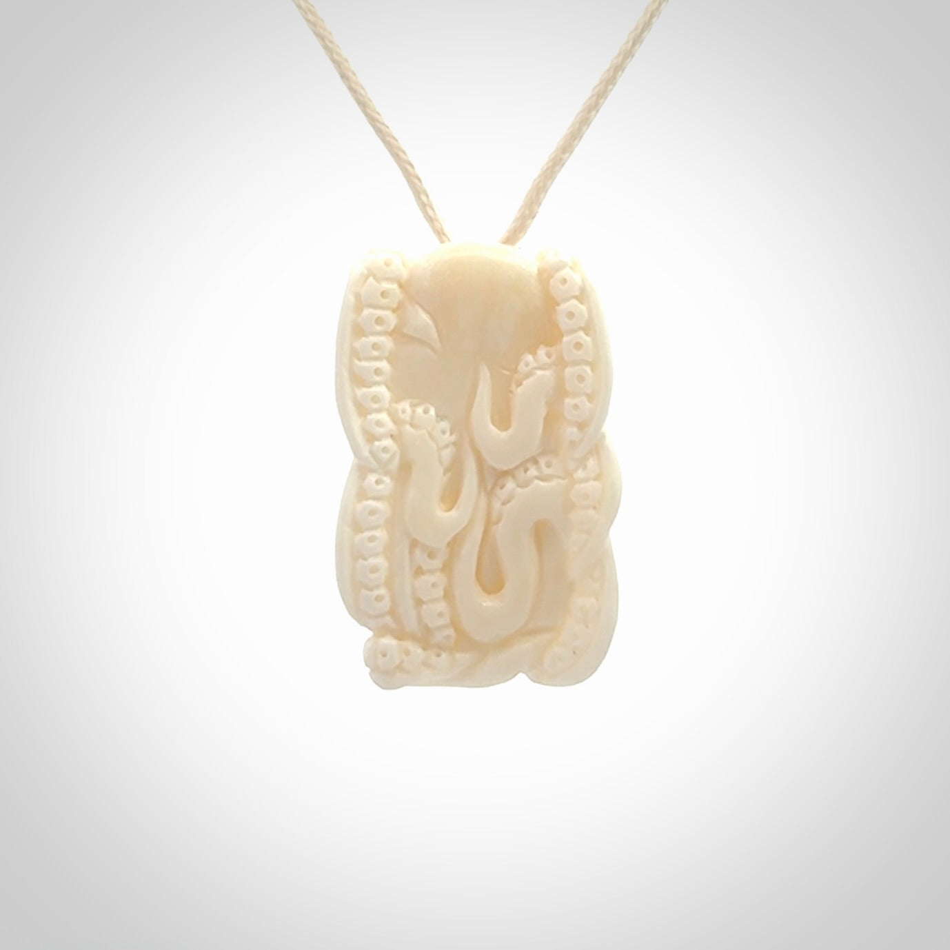This is a beautiful little hand carved octopus pendant. It is a very cute little pendant that we have carved in natural, untreated bone. We provide these with meringue adjustable cords and shipping is included worldwide.