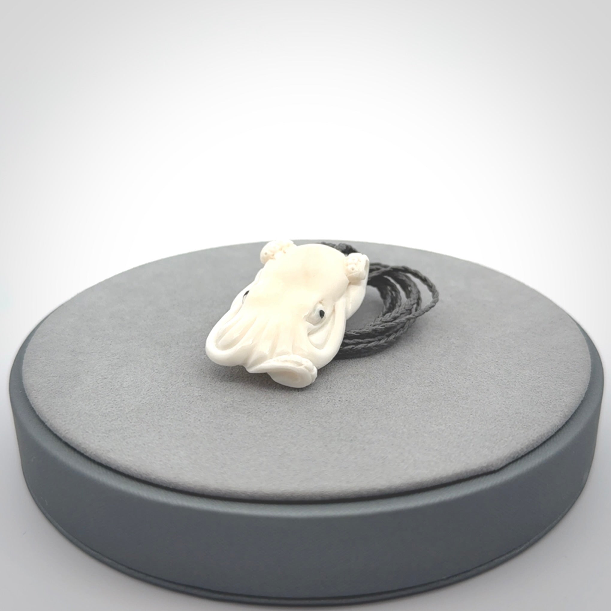 This is a beautiful little hand carved octopus pendant. It is a very cute little pendant that we have carved in natural, untreated bone. We provide these with adjustable cords and shipping is included worldwide.