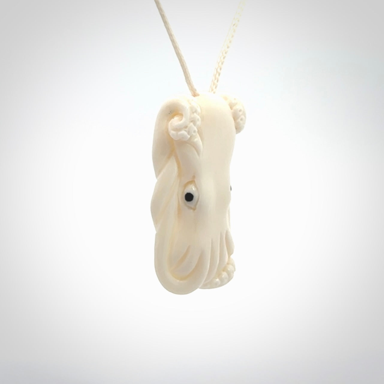 This is a beautiful little hand carved octopus pendant. It is a very cute little pendant that we have carved in natural, untreated bone. We provide these with meringue adjustable cords and shipping is included worldwide.