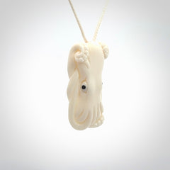 This is a beautiful little hand carved octopus pendant. It is a very cute little pendant that we have carved in natural, untreated bone. We provide these with meringue adjustable cords and shipping is included worldwide.