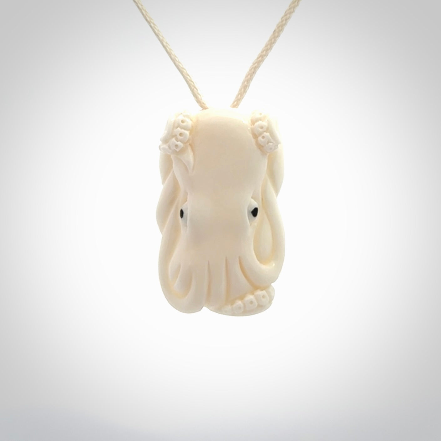 This is a beautiful little hand carved octopus pendant. It is a very cute little pendant that we have carved in natural, untreated bone. We provide these with meringue adjustable cords and shipping is included worldwide.
