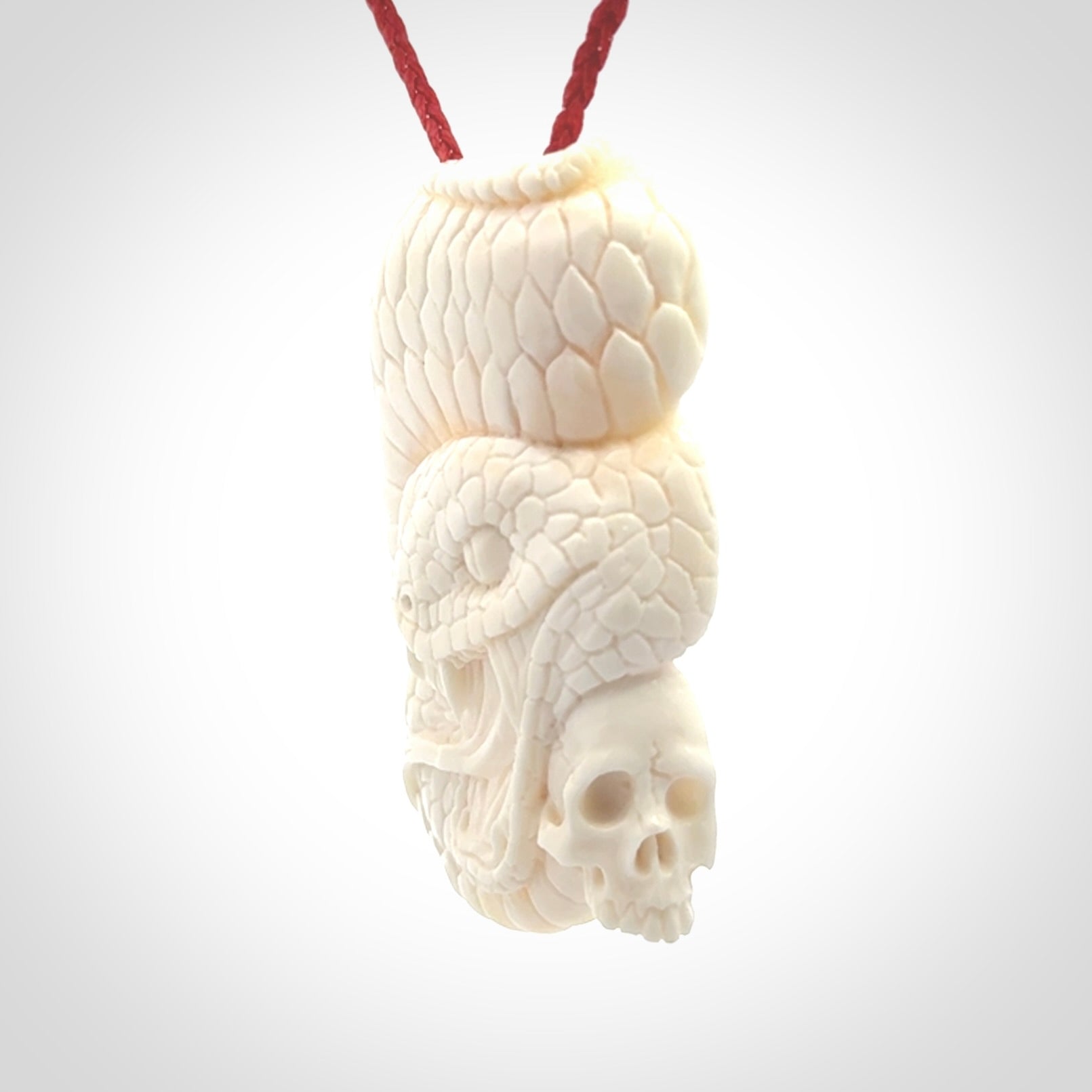 Hand carved bone snake skull pendant. Hand carved by NZ Pacific. Free postage worldwide. Hand made snake with skull necklace from bone. Snake skull necklace for men and women.
