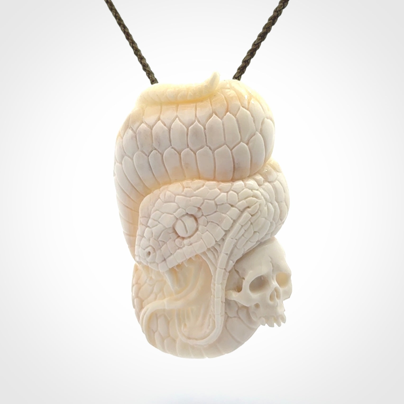 Hand carved bone snake skull pendant. Hand carved by NZ Pacific. Free postage worldwide. Hand made snake with skull necklace from bone. Snake skull necklace for men and women.