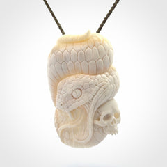 Hand carved bone snake skull pendant. Hand carved by NZ Pacific. Free postage worldwide. Hand made snake with skull necklace from bone. Snake skull necklace for men and women.