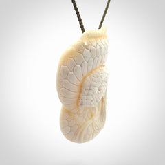 Hand carved bone snake skull pendant. Hand carved by NZ Pacific. Free postage worldwide. Hand made snake with skull necklace from bone. Snake skull necklace for men and women.