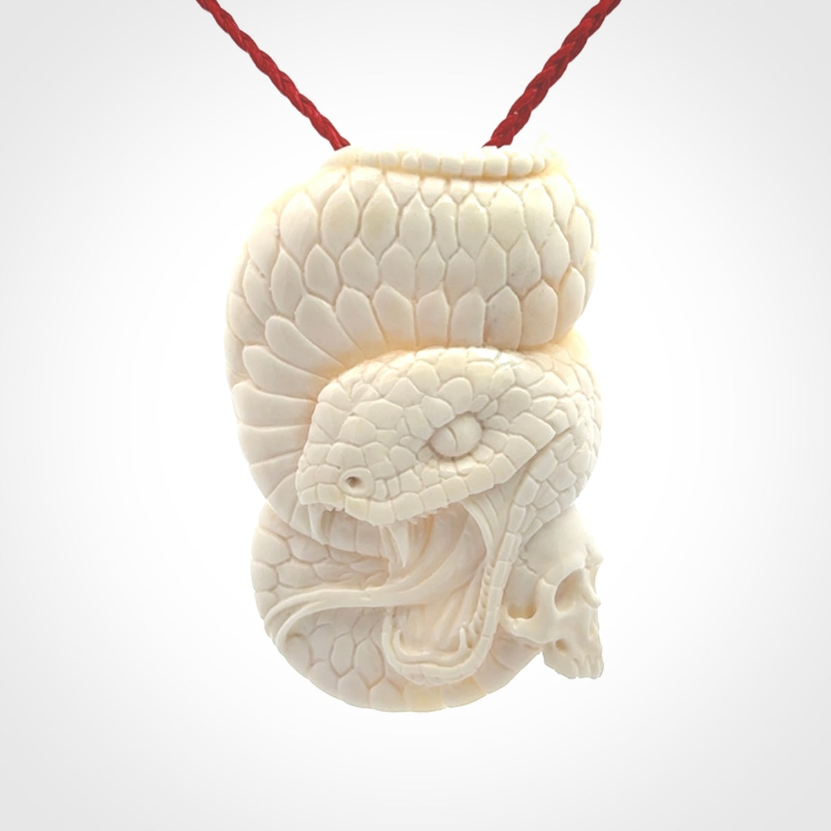 Hand carved bone snake skull pendant. Hand carved by NZ Pacific. Free postage worldwide. Hand made snake with skull necklace from bone. Snake skull necklace for men and women.