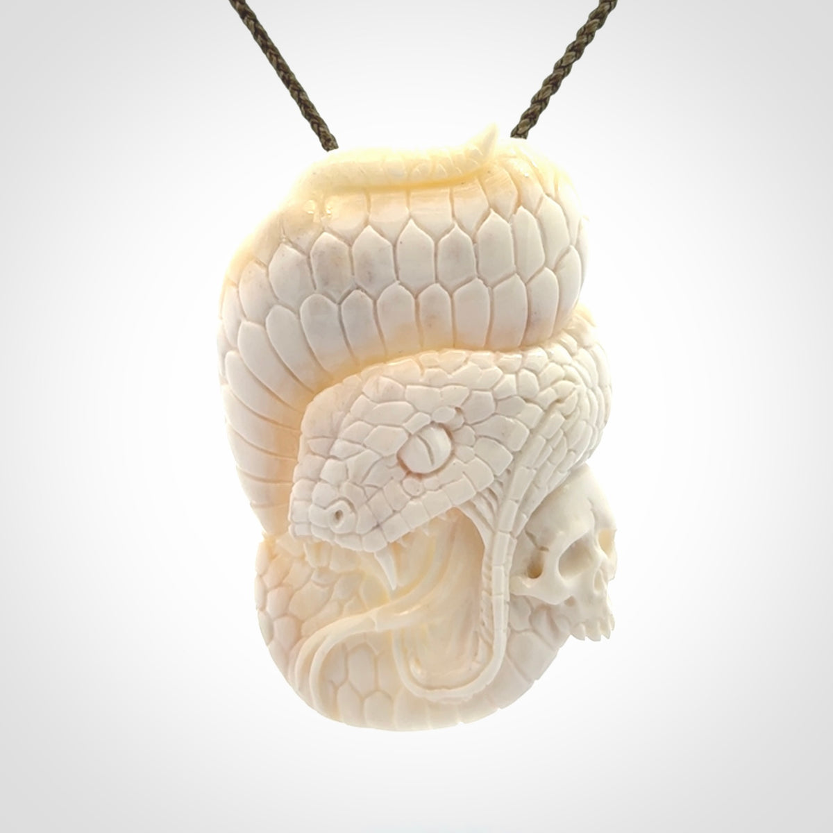 Hand carved bone snake skull pendant. Hand carved by NZ Pacific. Free postage worldwide. Hand made snake with skull necklace from bone. Snake skull necklace for men and women.