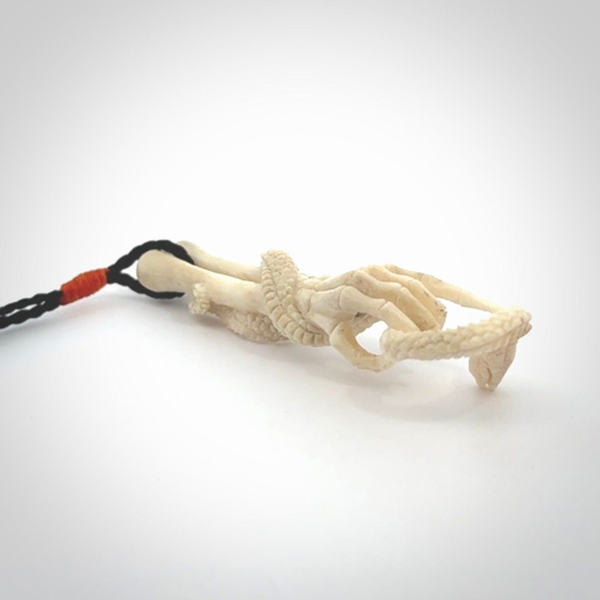 Hand carved deer antler skeleton hand with snake pendant. Hand carved by NZ Pacific. Free postage worldwide. Hand made skeleton hand with snake necklace from deer antler. Skeleton hand with snake necklace for men and women.
