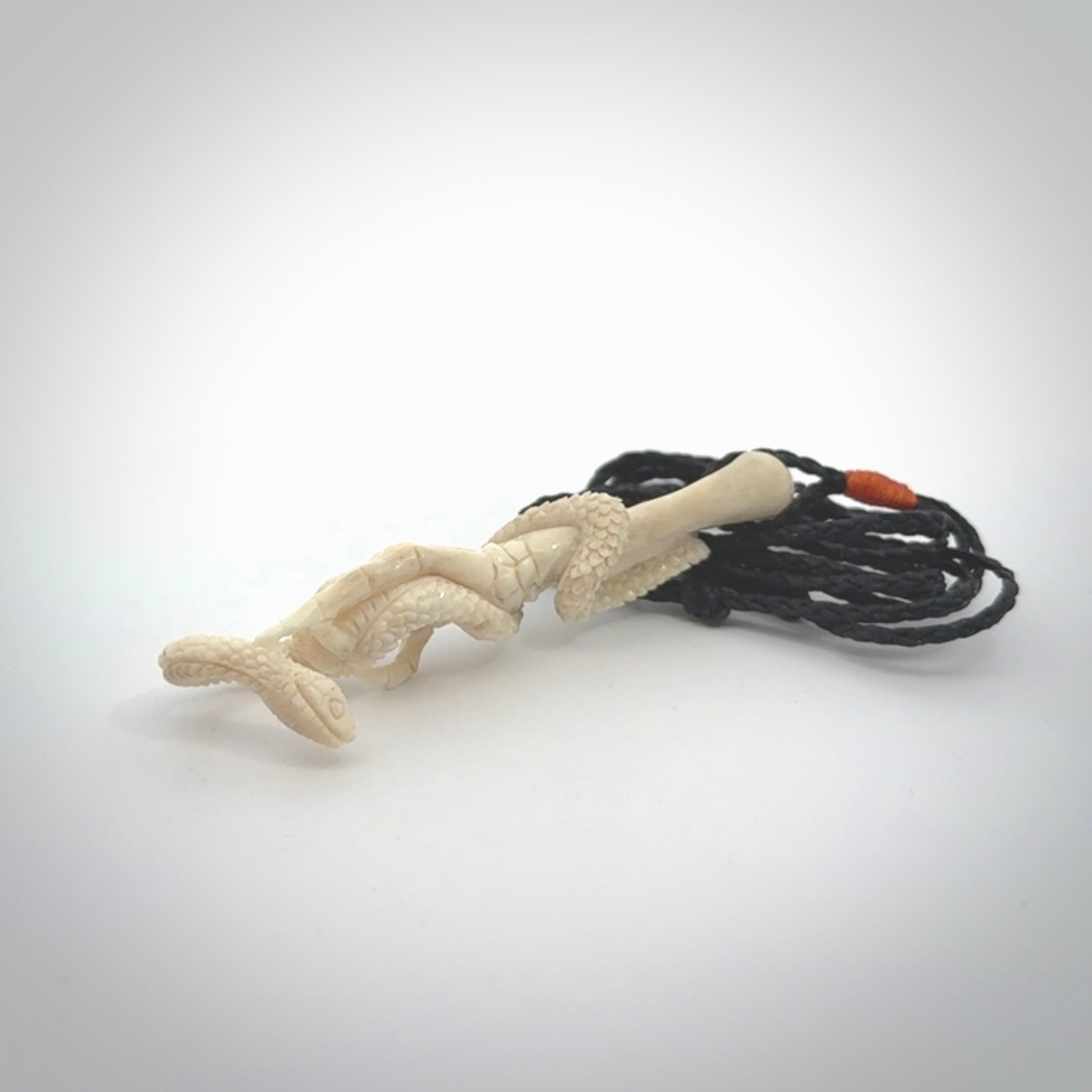 Hand carved deer antler skeleton hand with snake pendant. Hand carved by NZ Pacific. Free postage worldwide. Hand made skeleton hand with snake necklace from deer antler. Skeleton hand with snake necklace for men and women.
