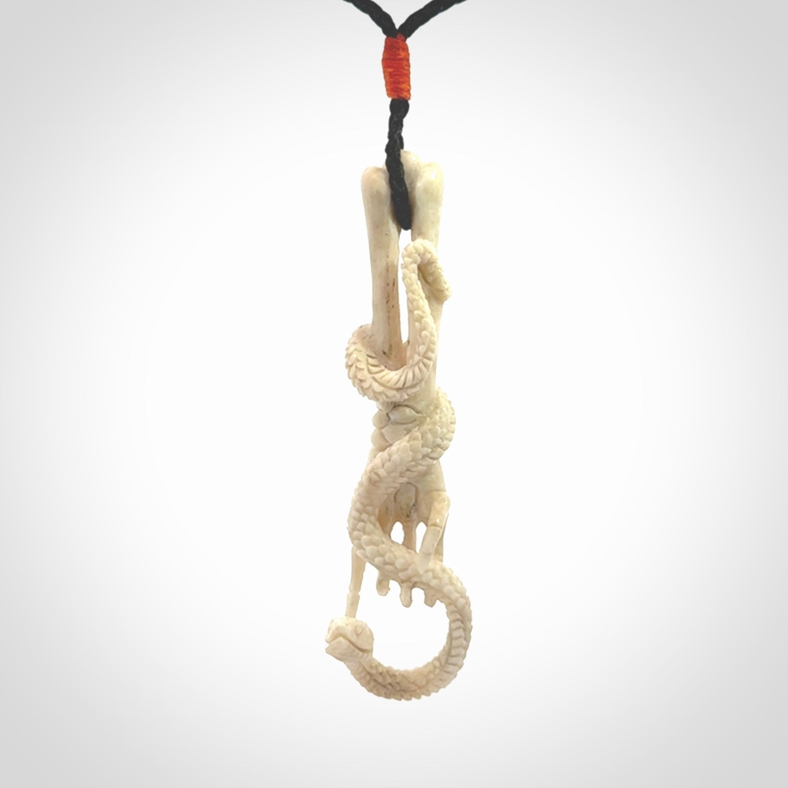 Hand carved deer antler skeleton hand with snake pendant. Hand carved by NZ Pacific. Free postage worldwide. Hand made skeleton hand with snake necklace from deer antler. Skeleton hand with snake necklace for men and women.