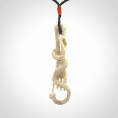 Hand carved deer antler skeleton hand with snake pendant. Hand carved by NZ Pacific. Free postage worldwide. Hand made skeleton hand with snake necklace from deer antler. Skeleton hand with snake necklace for men and women.