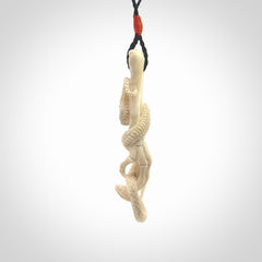 Hand carved deer antler skeleton hand with snake pendant. Hand carved by NZ Pacific. Free postage worldwide. Hand made skeleton hand with snake necklace from deer antler. Skeleton hand with snake necklace for men and women.