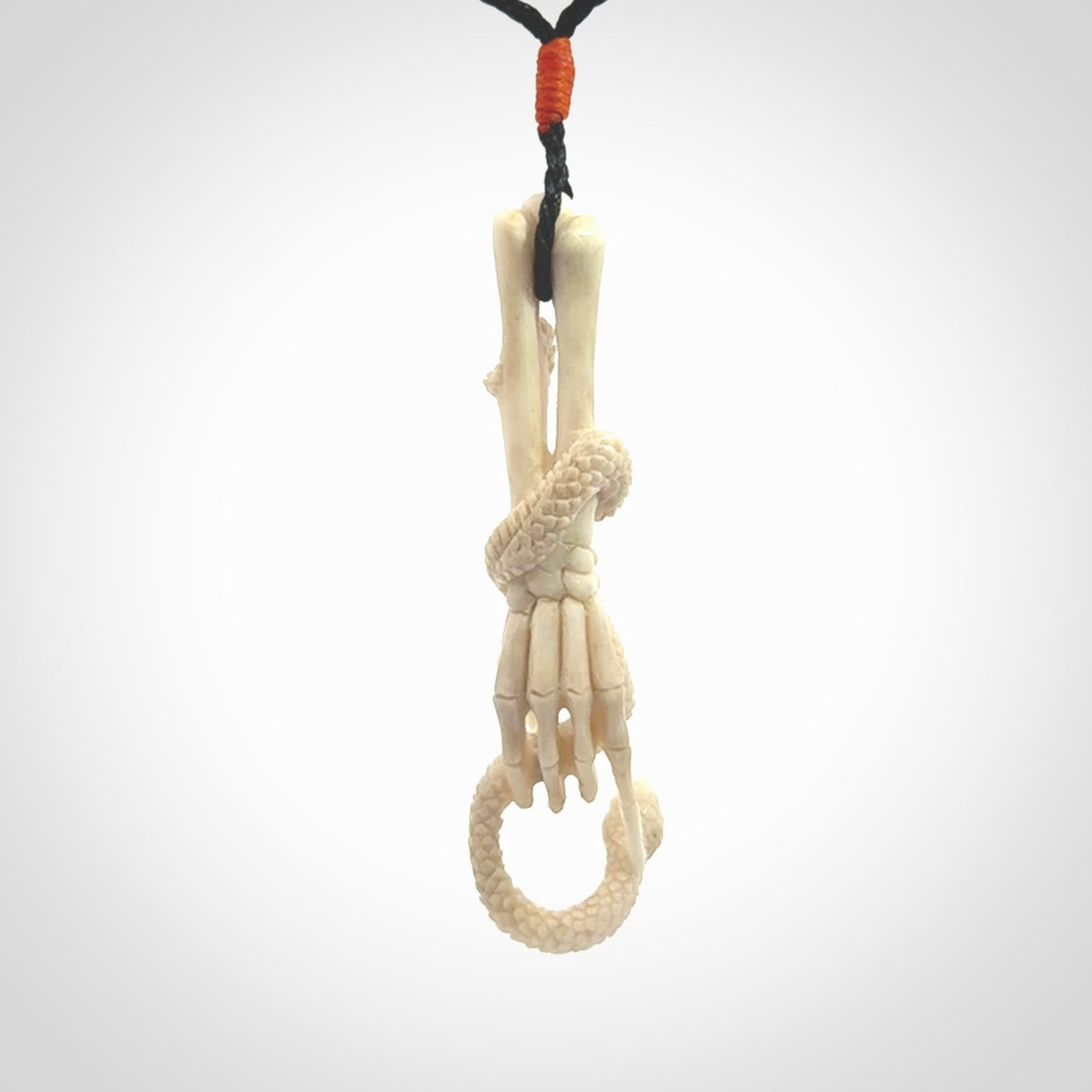 Hand carved deer antler skeleton hand with snake pendant. Hand carved by NZ Pacific. Free postage worldwide. Hand made skeleton hand with snake necklace from deer antler. Skeleton hand with snake necklace for men and women.