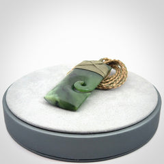 New Zealand jade toki koru pendant. Hand carved in New Zealand. Hand made New Zealand Jade jewellery. Provided with an adjustable cord and packaged in a woven kete pouch.