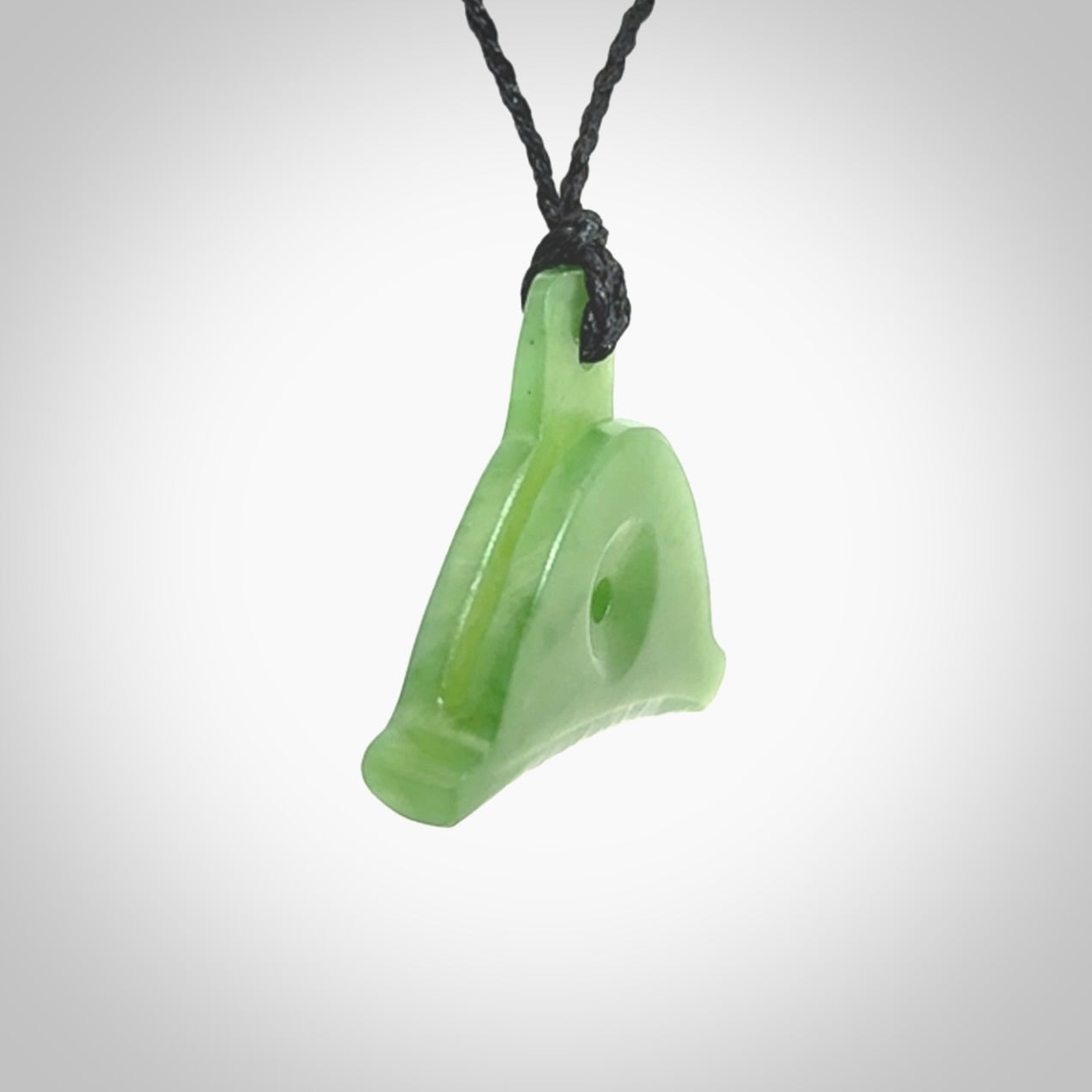 Hand carved New Zealand jade dog whistle. Carved for NZ Pacific by master carver Ross Crump. Jade dog whistle pendant provided with adjustable cord and delivered with express courier.