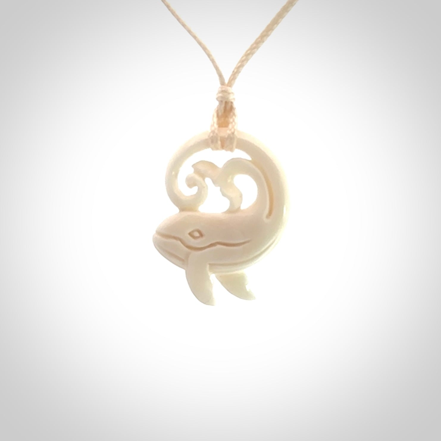 A hand carved bone whale pendant. This is a lovely piece carved to bring pleasure to the lucky wearer. It is a friendly pendant which we will ship to you free wherever you live. Carved by NZ Pacific and for sale online. Provided with an adjustable cord.