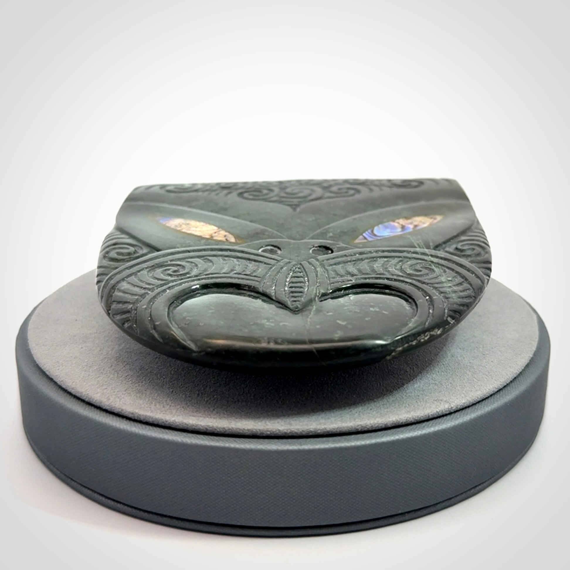 Hand carved New Zealand Jade wheku pendant with paua shell eyes