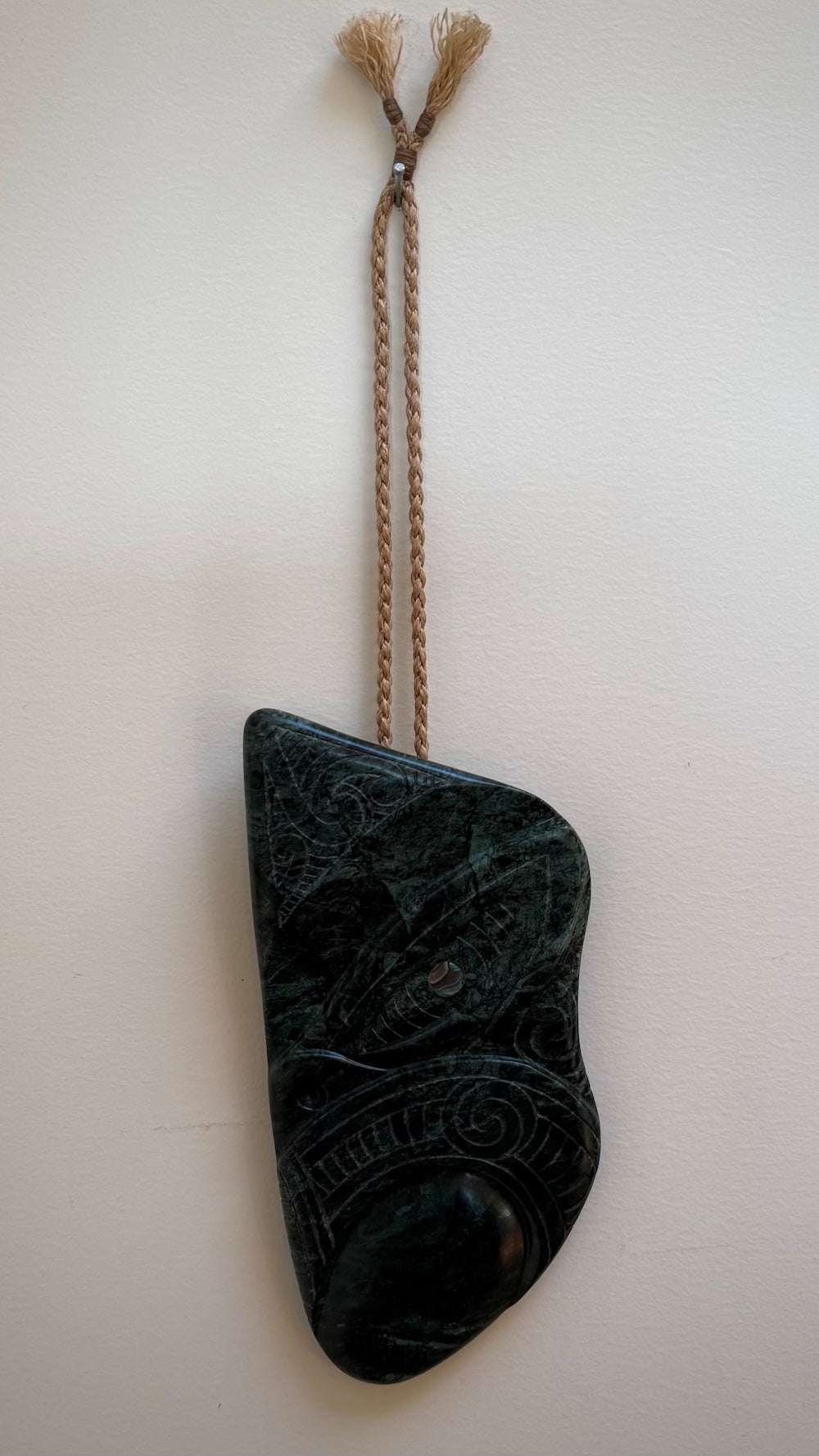 This is a large hand carved New Zealand Jade wheku pendant. It is made from New Zealand Jade and Paua shell.