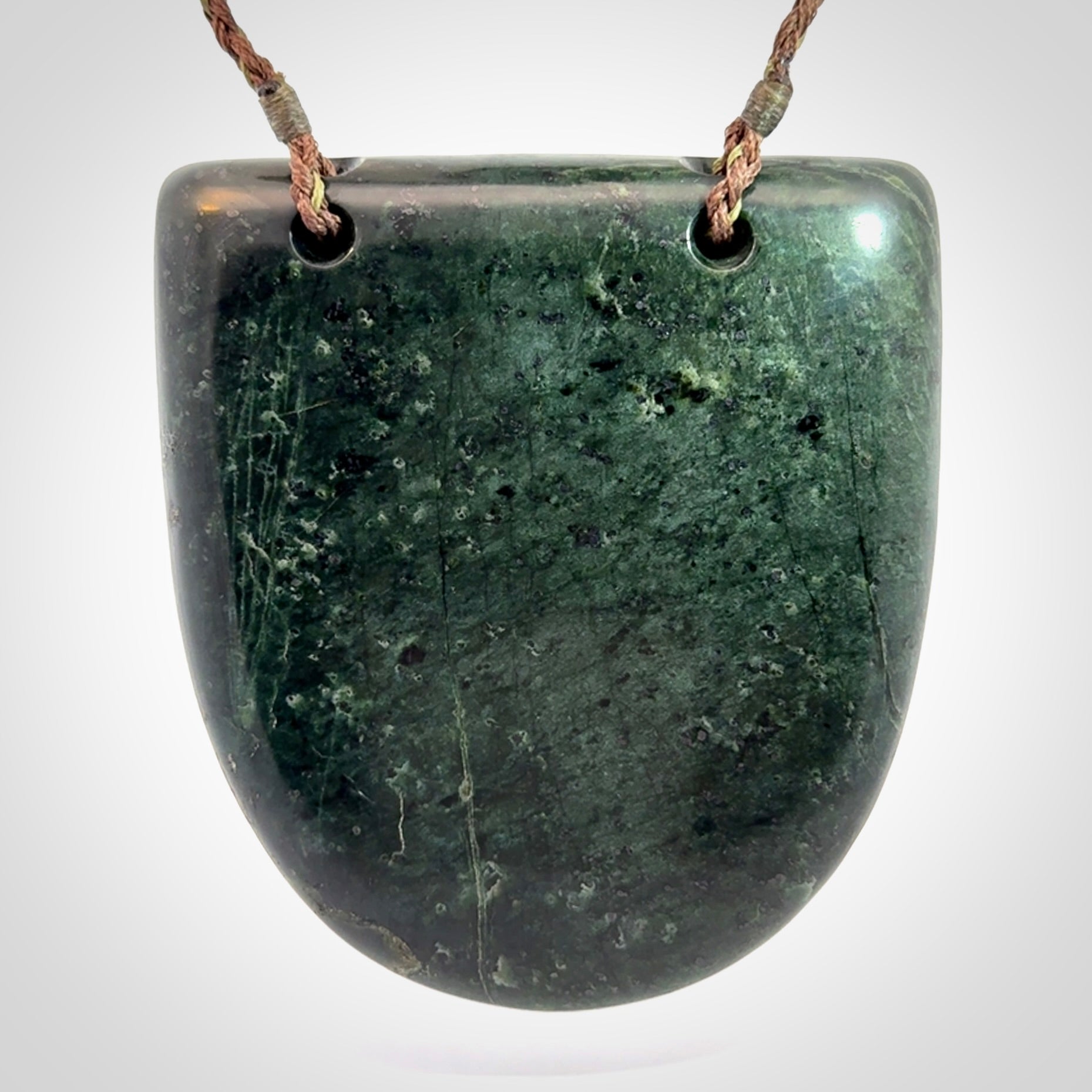 Hand carved New Zealand Jade wheku pendant with paua shell eyes