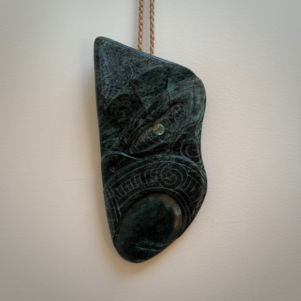 This is a large hand carved New Zealand Jade wheku pendant. It is made from New Zealand Jade and Paua shell.