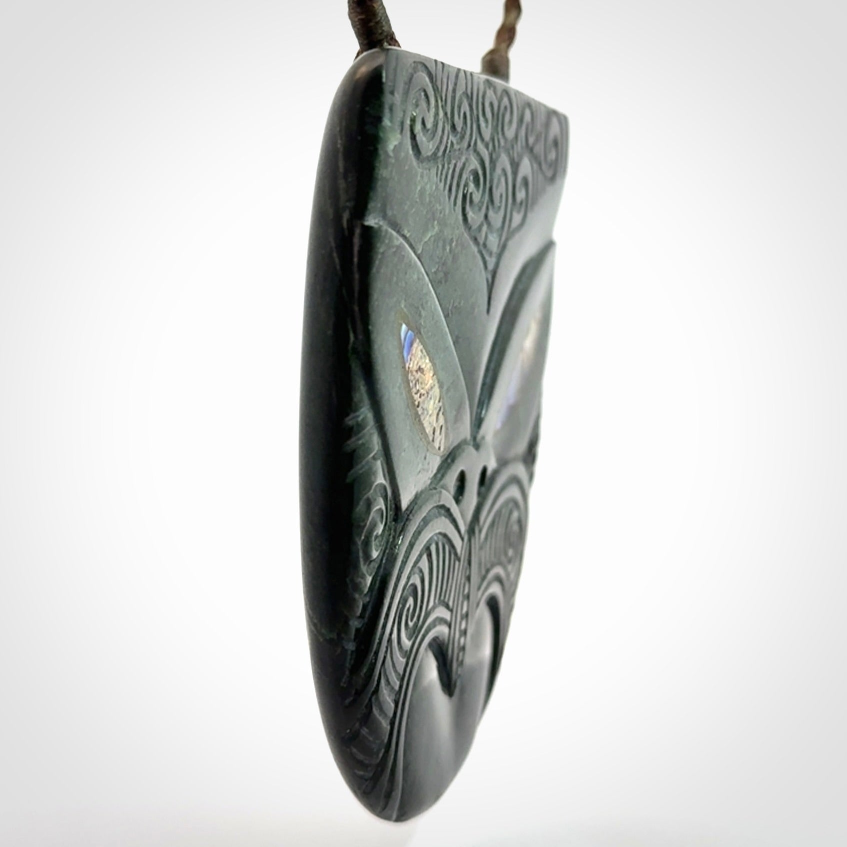 Hand carved New Zealand Jade wheku pendant with paua shell eyes