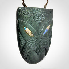 Hand carved New Zealand Jade wheku pendant with paua shell eyes