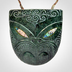 Hand carved New Zealand Jade wheku pendant with paua shell eyes