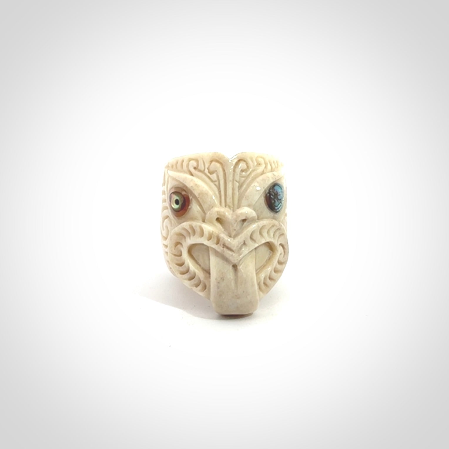 Hand carved deer antler wheku rings with paua shell eyes.