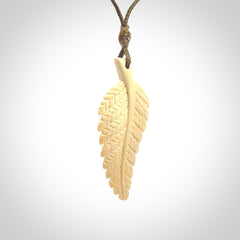 Hand carved woolly mammoth tusk fern pendant. Made in New Zealand. Unique hand made gifts from NZ Pacific. Hand carved fern necklace from ancient woolly mammoth tusk.