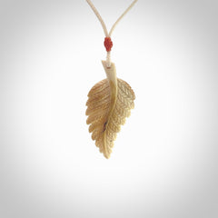 Hand carved woolly mammoth tusk fern pendant. Made in New Zealand. Unique hand made gifts from NZ Pacific. Hand carved fern necklace from ancient woolly mammoth tusk.